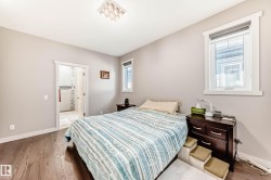 Bedroom featuring wood finished floors and connected bathroom - 