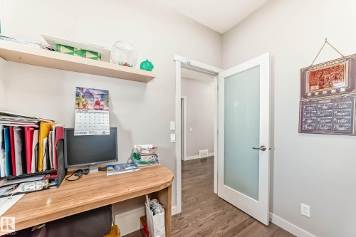 Office area with wood finished floors and baseboards - 7719 Getty Wynd, Edmonton, AB - Indoor Photo Showing Office