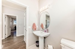 Half bath featuring toilet and wood finished floors - 