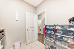 Laundry area featuring washer / dryer and light tile patterned floors - 
