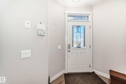Doorway with baseboards and wood finished floors - 