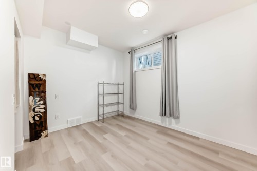 Unfurnished room with light wood-type flooring - 7719 Getty Wynd, Edmonton, AB - Indoor Photo Showing Other Room