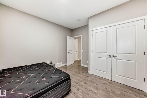 Bedroom featuring a closet and light wood-style flooring - 7719 Getty Wynd, Edmonton, AB - Indoor