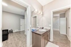 Bathroom with vanity and light wood finished floors - 