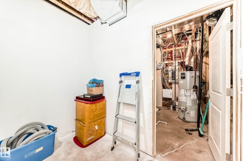 Utilities with gas water heater and electric panel - 7719 Getty Wynd, Edmonton, AB - Indoor Photo Showing Other Room