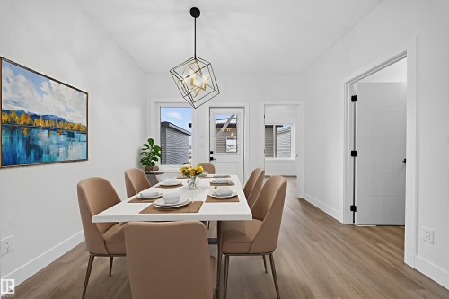 Dining room with hanging lights and light wood finished floors - 436 Crystal Creek Link, Leduc, AB - Indoor Photo Showing Dining Room