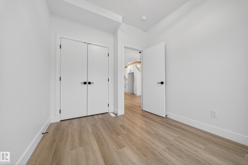 Unfurnished bedroom featuring light wood-style flooring and a closet - 436 Crystal Creek Link, Leduc, AB - Indoor Photo Showing Other Room