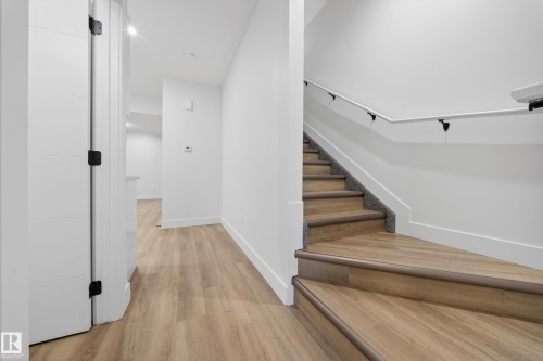 Stairs with baseboards and wood finished floors - 436 Crystal Creek Link, Leduc, AB - Indoor Photo Showing Other Room
