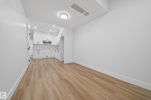 Unfurnished living room with baseboards and light wood-style floors - 436 Crystal Creek Link, Leduc, AB - Indoor Photo Showing Other Room