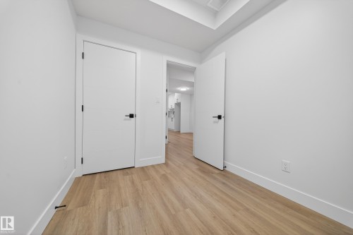 Unfurnished bedroom featuring baseboards and light wood-style floors - 436 Crystal Creek Link, Leduc, AB - Indoor Photo Showing Other Room