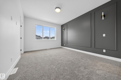 Spare room with light carpet and baseboards - 436 Crystal Creek Link, Leduc, AB - Indoor Photo Showing Other Room