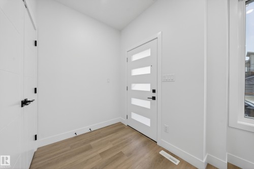 Foyer entrance featuring light wood-style flooring and baseboards - 436 Crystal Creek Link, Leduc, AB - Indoor Photo Showing Other Room