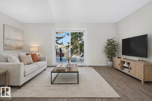 Living area with baseboards and wood finished floors - 9969 171 Ave, Edmonton, AB - Indoor Photo Showing Living Room
