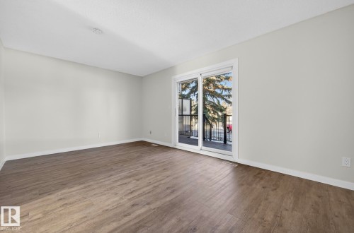 Unfurnished room with dark wood finished floors and baseboards - 9969 171 Ave, Edmonton, AB - Indoor Photo Showing Other Room