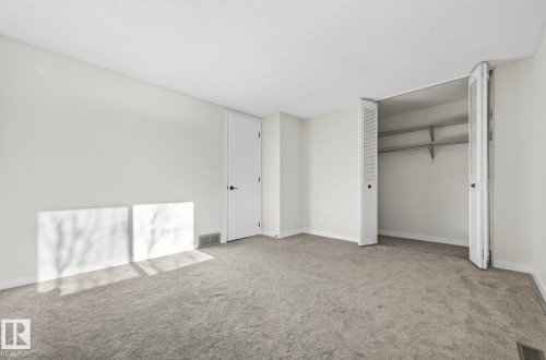 Unfurnished bedroom with light colored carpet and a closet - 9969 171 Ave, Edmonton, AB - Indoor Photo Showing Other Room