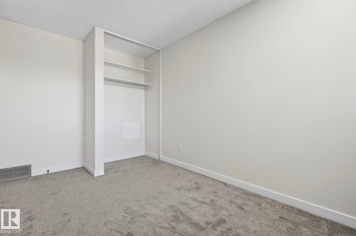 Unfurnished bedroom with light colored carpet and a textured ceiling - 9969 171 Ave, Edmonton, AB - Indoor Photo Showing Other Room