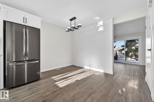 Unfurnished dining area featuring dark wood-style floors - 9969 171 Ave, Edmonton, AB - Indoor