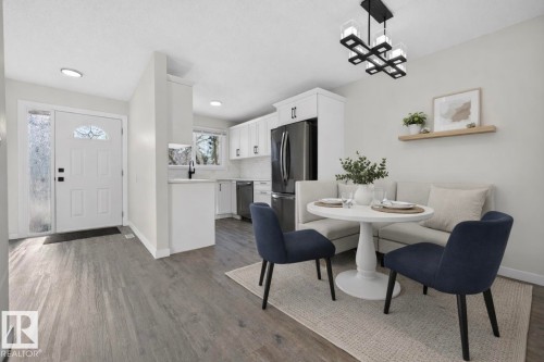 Dining area with dark wood finished floors and hanging lights - 9969 171 Ave, Edmonton, AB - Indoor Photo Showing Dining Room