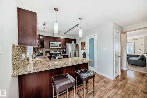 2 4950 Terwillegar Common, Edmonton, AB - Indoor Photo Showing Kitchen With Double Sink With Upgraded Kitchen