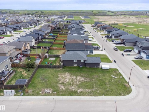 Vacant residential lot featuring a corner location, level ground, and surrounding residential properties - 4930 57 Avenue, Cold Lake, AB 