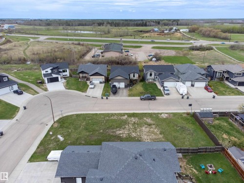 Residential street featuring contemporary homes with attached garages, paved driveways, and landscaped front yards - 4930 57 Avenue, Cold Lake, AB 