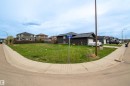 Corner lot featuring a grass expanse and concrete sidewalks - 4930 57 Avenue, Cold Lake, AB 