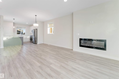560 Glenridding Ravine Drive Sw, Edmonton, AB - Indoor Photo Showing Living Room With Fireplace