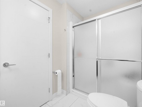 Bathroom with a shower stall and light marble finish floors - 5423 Chappelle Road, Edmonton, AB - Indoor Photo Showing Bathroom