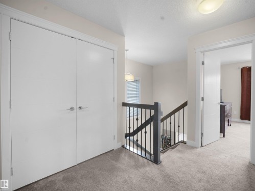 Hall featuring an upstairs landing, carpet, and a textured ceiling - 5423 Chappelle Road, Edmonton, AB - Indoor Photo Showing Other Room