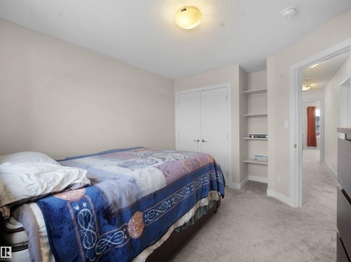 Bedroom featuring light colored carpet, a closet, and a textured ceiling - 5423 Chappelle Road, Edmonton, AB - Indoor Photo Showing Bedroom