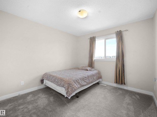 Bedroom featuring baseboards and carpet - 5423 Chappelle Road, Edmonton, AB - Indoor Photo Showing Bedroom