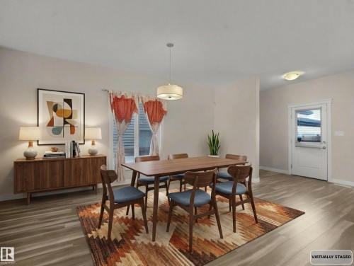 Dining space with wood finished floors and healthy amount of natural light - 5423 Chappelle Road, Edmonton, AB - Indoor Photo Showing Dining Room