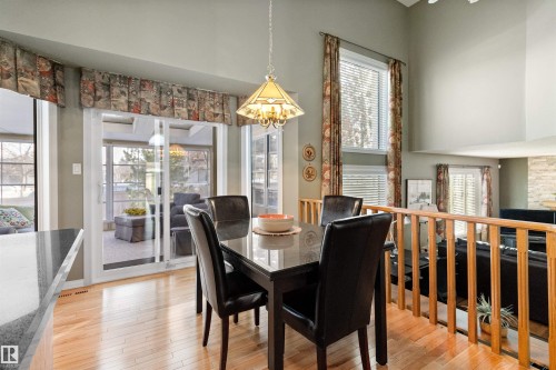 Dining room featuring suspended lighting, light wood-style floors, and a high ceiling - 519 Buchanan Road, Edmonton, AB - Indoor Photo Showing Dining Room