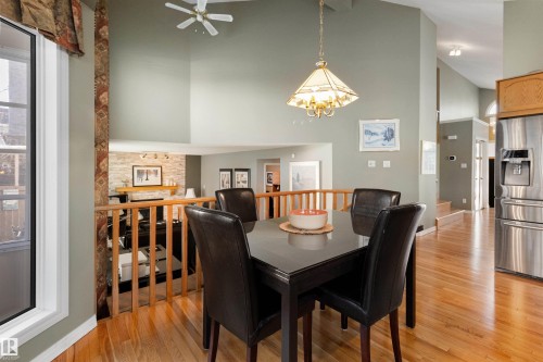 Dining space with light wood-type flooring, ceiling fan, lofted ceiling, and suspended lighting - 519 Buchanan Road, Edmonton, AB - Indoor Photo Showing Dining Room