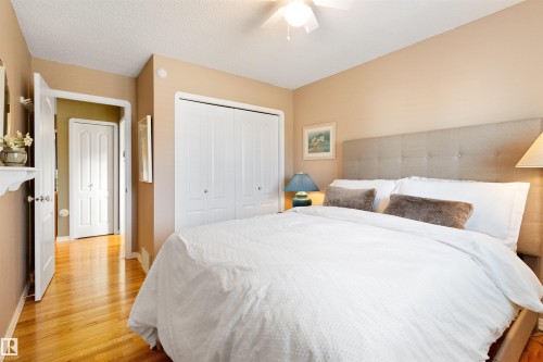 Bedroom featuring a closet, light wood-style floors, ceiling fan, and a textured ceiling - 519 Buchanan Road, Edmonton, AB - Indoor Photo Showing Bedroom
