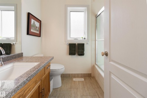 Full bath featuring vanity and combined bath / shower with glass door - 519 Buchanan Road, Edmonton, AB - Indoor Photo Showing Bathroom