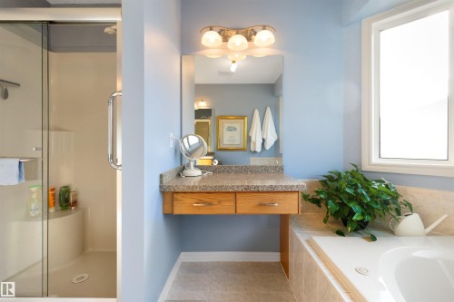 Bathroom with vanity, a stall shower, light tile patterned flooring, and a bath - 519 Buchanan Road, Edmonton, AB - Indoor Photo Showing Bathroom