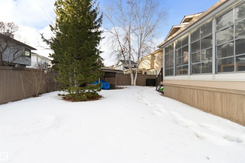 Yard covered in snow with a fenced backyard and a sunroom - 519 Buchanan Road, Edmonton, AB - Outdoor