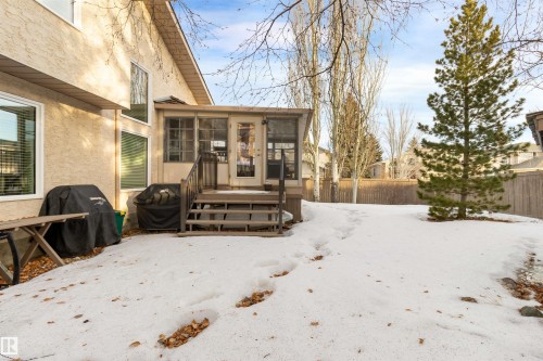 Snow covered property featuring a sunroom and stucco siding - 519 Buchanan Road, Edmonton, AB - Outdoor With Deck Patio Veranda