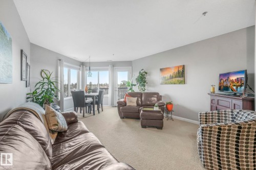 Carpeted living room with baseboards - 415 530 Hooke Road, Edmonton, AB - Indoor Photo Showing Living Room