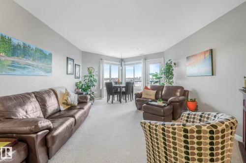Living room featuring carpet floors and baseboards - 415 530 Hooke Road, Edmonton, AB - Indoor Photo Showing Living Room
