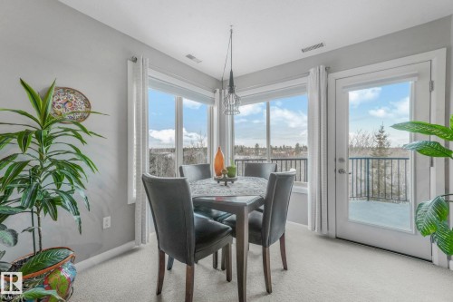 Dining space with light colored carpet and baseboards - 415 530 Hooke Road, Edmonton, AB - Indoor Photo Showing Dining Room