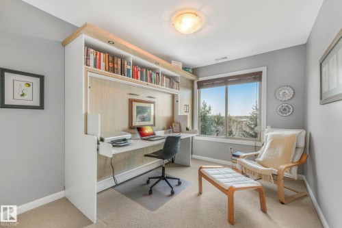 Office with light colored carpet and built in study area - 415 530 Hooke Road, Edmonton, AB - Indoor Photo Showing Office
