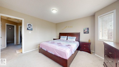 Bedroom featuring light carpet and a textured ceiling - 1150 37B Avenue, Edmonton, AB - Indoor Photo Showing Bedroom