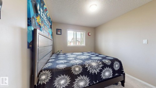 Bedroom featuring a textured ceiling and carpet flooring - 1150 37B Avenue, Edmonton, AB - Indoor Photo Showing Bedroom