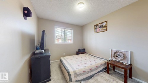 Bedroom with light colored carpet and a textured ceiling - 1150 37B Avenue, Edmonton, AB - Indoor Photo Showing Bedroom