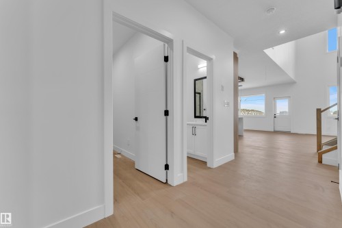 Corridor featuring light wood-style floors and recessed lighting - 202 Basin Court, Leduc, AB - Indoor Photo Showing Other Room