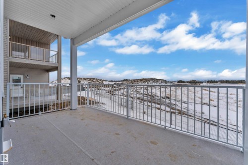 Snow covered patio with a balcony - 202 Basin Court, Leduc, AB - Outdoor With Exterior