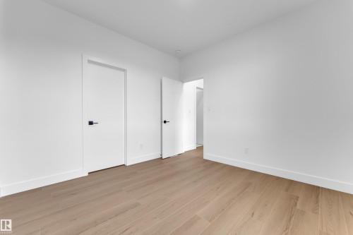 Unfurnished bedroom with light wood finished floors and baseboards - 202 Basin Court, Leduc, AB - Indoor Photo Showing Other Room