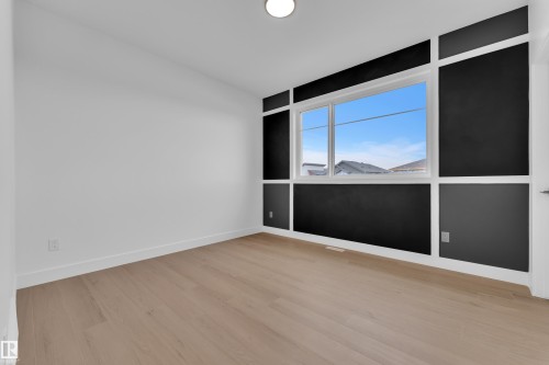 Unfurnished room with light wood-style flooring and baseboards - 202 Basin Court, Leduc, AB - Indoor Photo Showing Other Room
